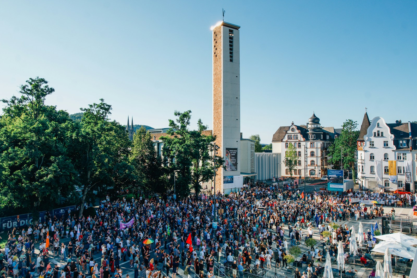 A large crowd of people standing in front of a tall building